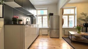 a kitchen with a refrigerator and a table in it at Bohemian Chic apartment in Kalamaja in Tallinn +2 photos