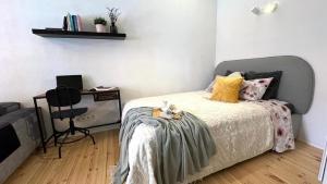 a bedroom with a bed with a stuffed animal sitting on it at Bohemian Chic apartment in Kalamaja in Tallinn