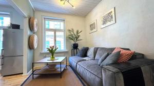 a living room with a couch and a table at Bohemian Chic apartment in Kalamaja in Tallinn