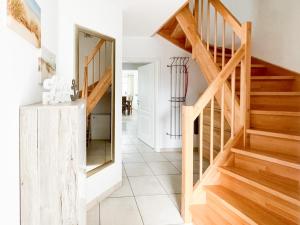 a staircase in a house with a mirror at Ferienhaus Meeresrauschen in Groß Kirr +11 photos