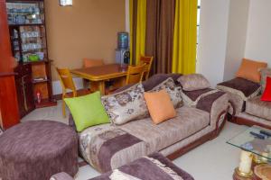 a living room with a couch and a table at Prissy Apartment in Nairobi