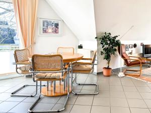 a dining room with a table and chairs at Windwatt 4 in Zingst
