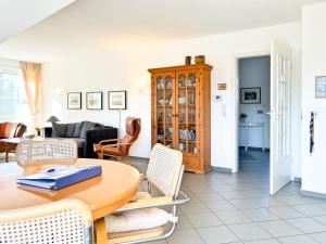 a living room with a table and chairs at Windwatt 4 in Zingst