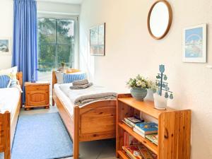 a bedroom with two beds and a mirror at Windwatt 4 in Zingst +1 photo