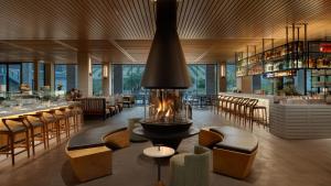 a restaurant with a fireplace and chairs and a bar at Appellation Healdsburg in Healdsburg