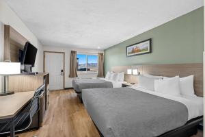 a hotel room with two beds and a flat screen tv at Quality Inn Beaver I-15 in Beaver +67 photos