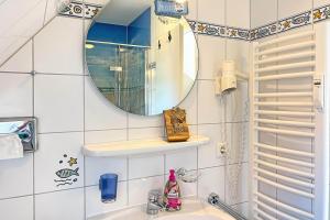 a bathroom with a sink and a mirror at Ostseeauszeit in Prerow +4 photos