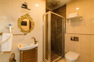 a bathroom with a shower and a toilet and a sink at BeyPort Hotel Istanbul in Istanbul +42 photos