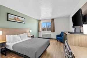 a hotel room with a bed and a tv at Quality Inn Beaver I-15 in Beaver