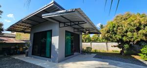 a detached house with awning and a patio at ST house in Ban Nua Khlong