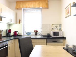 a kitchen with a table and a microwave at Inselperle in Zingst