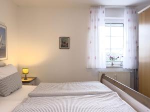 a bedroom with two beds and a window at Inselperle in Zingst +1 photo