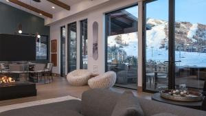 a living room with a fireplace and a view of a mountain at Aria Ridge in Steamboat Springs