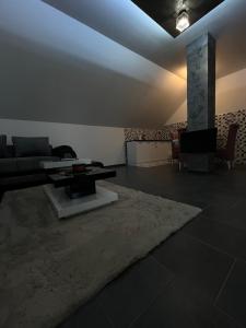 a living room with a couch and a table at Crassula Lux in Surčin