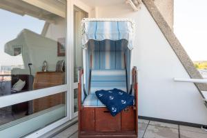 a chair sitting on the porch of a balcony at Kiel Water 4 in Schilksee