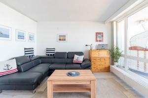 a living room with a couch and a coffee table at Kiel Water 4 in Schilksee