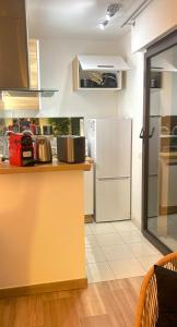 a kitchen with a white refrigerator and a counter at Beautiful 36m2 studio apartment & 50m2 terrace in Cannes