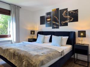 a bedroom with a king sized bed with two lamps at Haus am Strand in Zingst