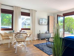 a living room with a table and chairs at Haus am Strand in Zingst