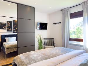 a bedroom with a bed and a chair and a window at Haus am Strand in Zingst +9 photos