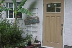 a door to a house with a sign on it at Nesting Ravens cottage in Nanaimo