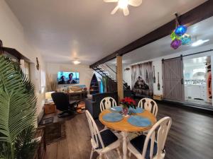 a dining room and living room with a table and chairs at Nesting Ravens cottage in Nanaimo