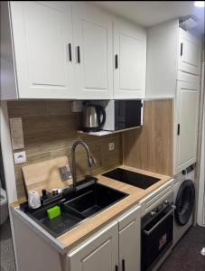 a kitchen with white cabinets and a sink at WKI Company in Mannheim
