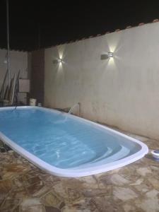 a large blue tub in a room with lights at Espaço Dtalia in Piedade