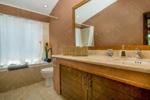 ein Badezimmer mit Waschbecken, Spiegel und Toilette in der Unterkunft Faro de Mita four bedroom Luxury Condo Walk to Town in Punta Mita