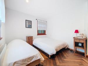 En eller flere senge i et værelse på Les Perles du Ried - Gîte 201