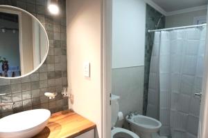 a bathroom with a sink and a toilet and a shower at Blanco Jazmines in Concepción del Uruguay