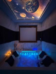 a room with a bath tub with a visualization of planets at Glamoon Mountain Apartment with Jacuzzi and Sauna, Nowy Targ in Nowy Targ