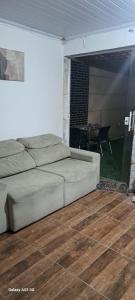 a living room with a bed and a table at Fundilhos House in Rio das Ostras