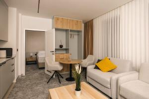 a living room with a couch and a table at Hotel Opal Casa in Novi Pazar
