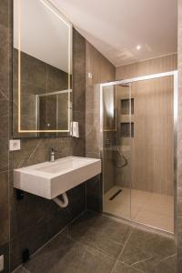 a bathroom with a sink and a shower at Hotel Opal Casa in Novi Pazar +12 photos