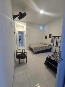a room with two beds and a chair in it at Casa Maúna in Prea