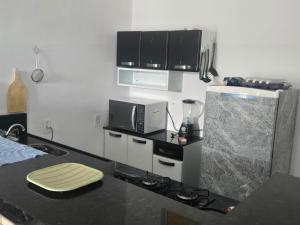 a kitchen with a counter top with a microwave at Casa Maúna in Prea +14 photos