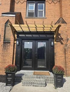 a black door with a wooden roof on a building at The Gratiot in Detroit