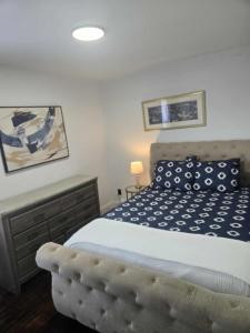 a bedroom with a bed with a blue and white comforter at The Gratiot in Detroit +3 photos