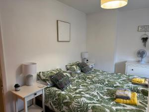a bedroom with a bed and a table with a lamp at Henley Town Rooms in Henley on Thames
