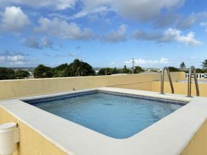 a swimming pool on the roof of a house at 8 Coral Haven in Christ Church