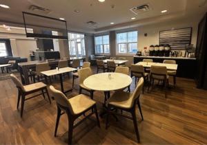 a restaurant with tables and chairs in a room at Residence Inn Paducah in Paducah