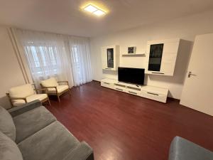 a living room with a couch and a flat screen tv at Ferienwohnung-Montagewohnung 4 in Paderborn