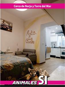a dog laying next to a bed in a room at Apartamento La Cueva in Algarrobo
