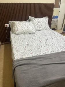a bed with pillows and a comforter on it at A casa do Breno in São José da Coroa Grande