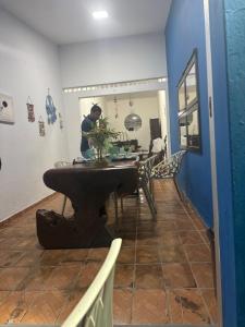 a man sitting at a table in a room at A casa do Breno in São José da Coroa Grande