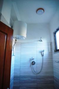 a bathroom with a shower with a glass door at Kings Land Hotel in Lalībela
