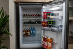 an open refrigerator filled with drinks and drinks at Home Very Close To CBD in Gaborone
