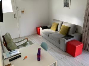 a living room with a couch and a table at Jetty Rd Granny Flat in Normanville
