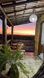 a patio with a table and a chandelier at Chalés Calica in Caraíva